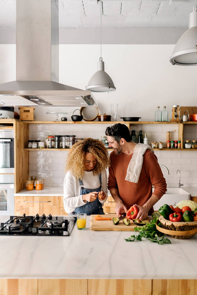 Couple preparing food in kitchen. - Fotó, kép