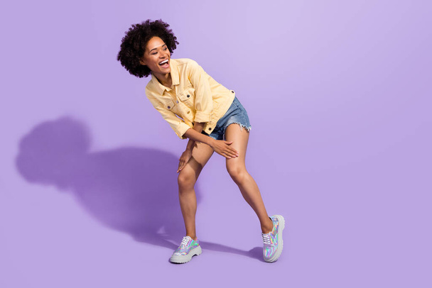 Photo of charming sweet woman dressed yellow jeans jacket smiling dancing isolated purple color background - Fotografie, Obrázek