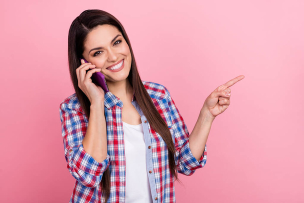 Photo of attractive hispanic girl speaking with friends on phone promote advert product isolated on pink color background - Fotó, kép
