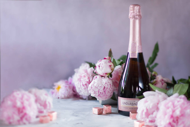 As, Belgium 8 June 2020, Undurraga pink dry champagne with peonies - Zdjęcie, obraz