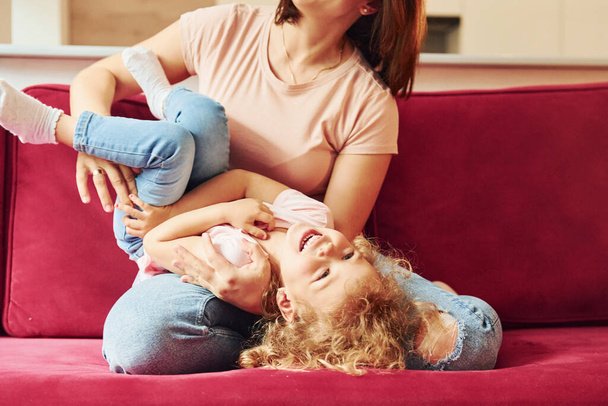 Young mother with her little daughter in casual clothes together indoors at home. - Foto, imagen