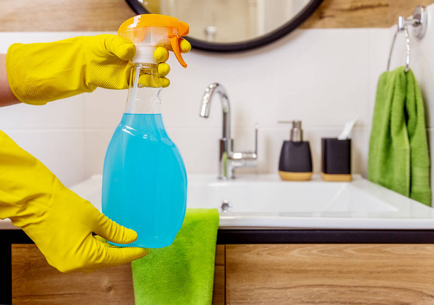 maqueta de una botella de líquido limpiador para la limpieza en el baño. manos femeninas - Foto, Imagen