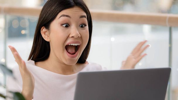 Korean Asian woman with laptop luck excited surprised feels very happy got university scholarship win online auction victory winning emotion female winner celebrate triumph scream with joy achievement - Photo, Image