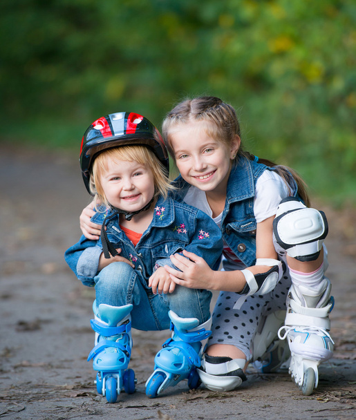Two little girls on rollers - Фото, изображение