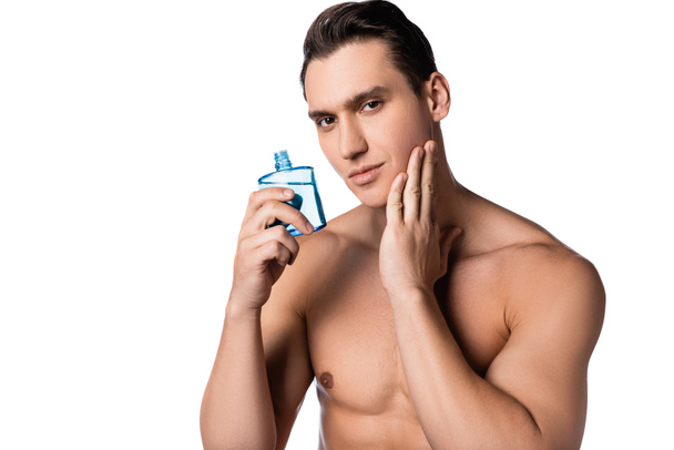 man with naked chest applying after shave lotion isolated on white - Photo, Image
