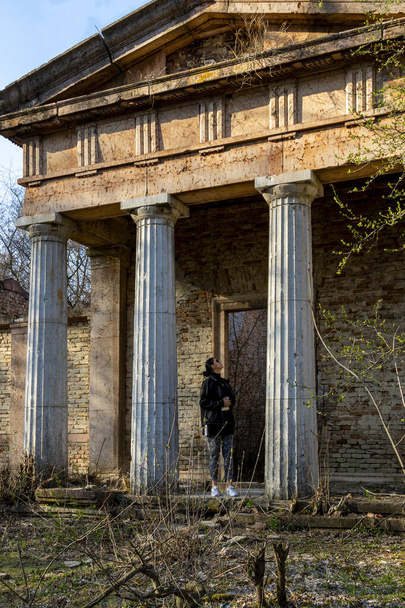 Hungary Bicske Mar. 2, 2022: Unidentified lady at a ruins in the countryside in the forest. - Фото, зображення