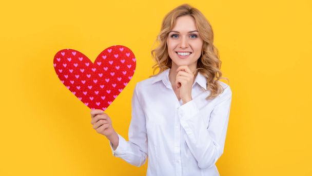 happy woman with red love heart on yellow background. sweetheart - Photo, Image