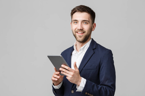 Business Concept - Portrait Handsome Business man playing digital tablet with smiling confident face. White Background. Copy Space. - Foto, imagen