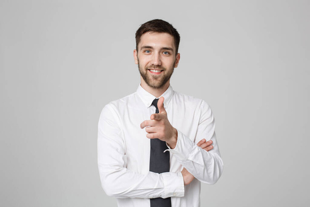 Young successful businessman pointing direction with finger over dark grey background. Copy space. - Photo, Image