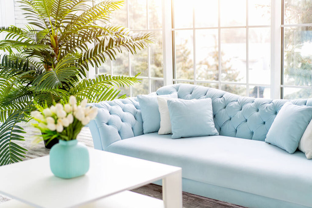 Luxury house interior. ELegant living room Modern Interior design. White Living Room Tulip flowers standing vase on coffee table - Photo, image