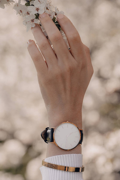 Stylish white watch on woman hand - Foto, Imagen