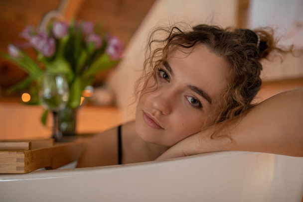 Portrait of charming brown- haired woman in close -up,taking bath in her country house . Skin and hair care. Rest in hotel in mountains. Luxury and pleasure. - Foto, immagini