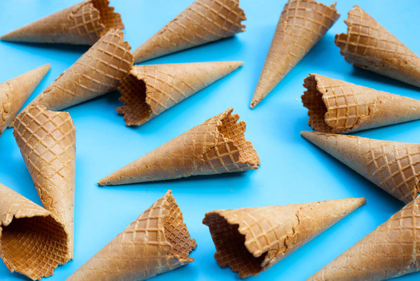 Empty ice cream cone on blue background. - Fotografie, Obrázek