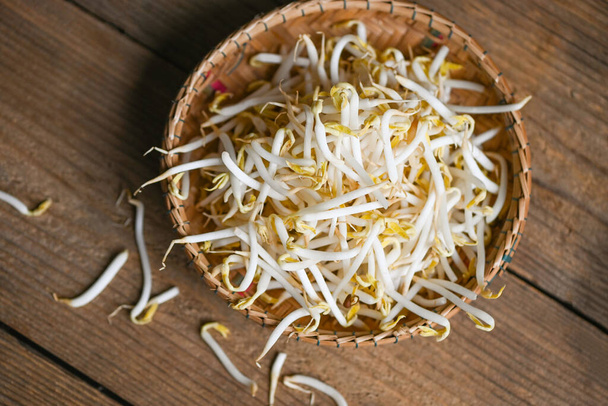Bonen spruiten op houten mand tafel achtergrond in de keuken, Rauwe witte biologische bonen spruiten of mung boon spruit voor voedsel veganistisch - Foto, afbeelding