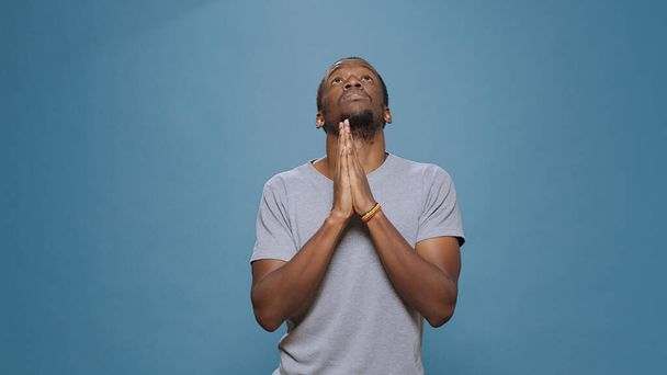 Male model holding hands in prayer to do spiritual session - Foto, Imagen