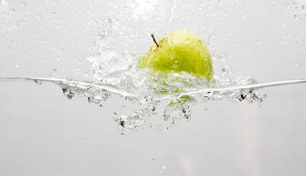 High speed photography of an apple entering a pond of water - Fotoğraf, Görsel