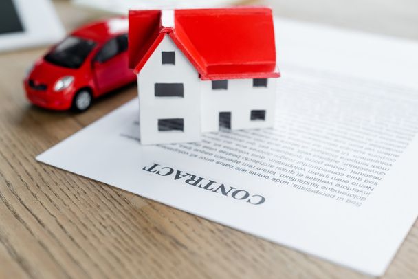 house model and toy car on contract, tax inspection concept - Foto, Imagem
