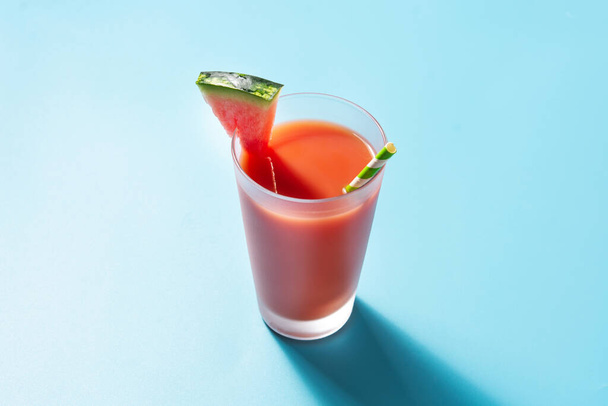 Fresh watermelon juice on blue background - 写真・画像