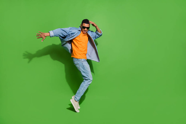 Full body image of good mood young man have fun relaxing on weekend in nightclub isolated on green color background - Foto, Bild