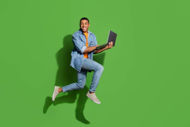 Full size profile side photo of intelligent young businessman working on new project isolated on green color background - Foto, Imagem