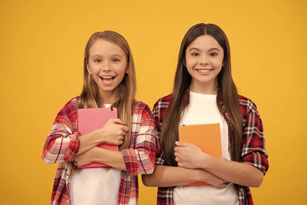 cheerful kids going to do homework with books. smiling teenager student. education. - Zdjęcie, obraz
