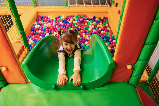 Happy little girl in casual clothes have fun in children's game complex. - Fotografie, Obrázek