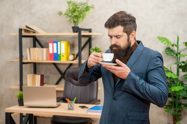 mature entrepreneur in jacket enjoy smell having coffee break at office, morning - Foto, imagen