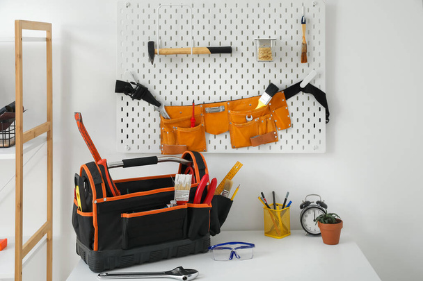 Workplace and pegboard with different tools in workshop - Foto, imagen
