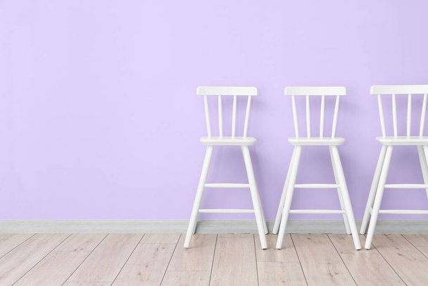 White chairs near violet wall - Photo, Image