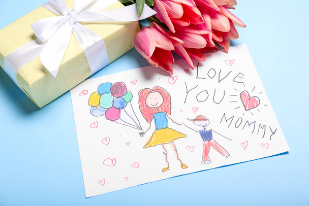 Picture with text LOVE YOU MOMMY, tulips and gift box on blue background - Fotó, kép