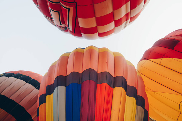 Group of vivid envelope of hot air balloons before floating as seen from below. - Φωτογραφία, εικόνα