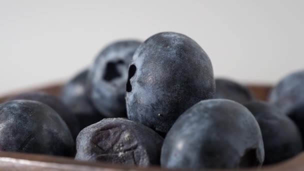 blueberries in a wooden cup on a white background. blueberries close-up. - Footage, Video
