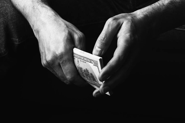 Male hands holding us hundred dollars banknotes - Fotoğraf, Görsel
