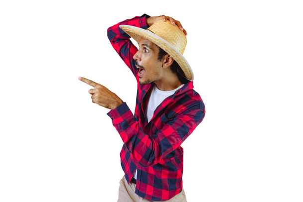 Man With Hat and Junina Party Shirt Isolated on White Background. Young man wearing traditional clothes for Brazilian June festival. - Zdjęcie, obraz