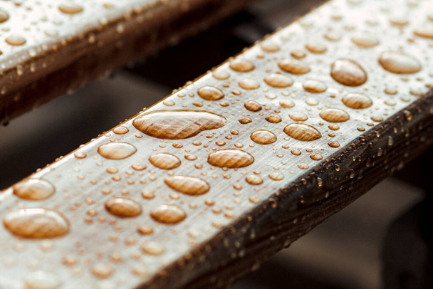 wet wooden planks of bench, background of wood texture with water drops from the rain - Foto, imagen
