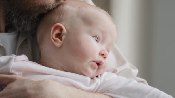 Unrecognizable bearded father daddy caring parent holding caucasian baby kissing child head expressing love paternal protection adoption kid newborn infant daddy kiss daughter parental tenderness - Footage, Video