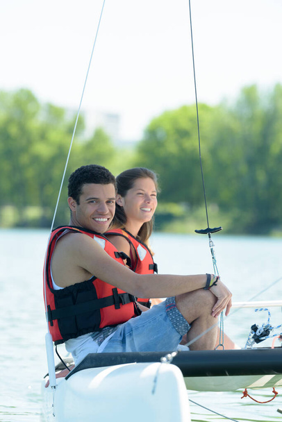 couple erecting sail on boat - Foto, immagini