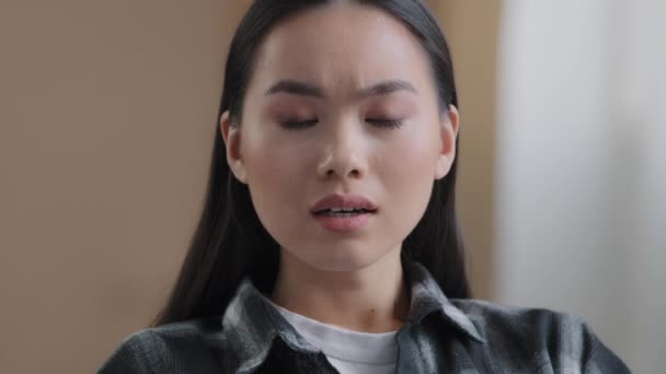 Female emotional portrait Asian girl shock surprise disappointment sadness bad mood negative reaction. Headshot Korean woman looking at camera with upset expression sad lady misunderstanding at home - Footage, Video