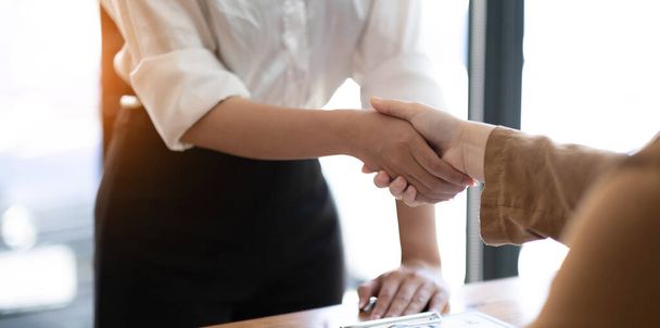 Real estate agents and customers shake hands to congratulate on signing a contract to buy a house with land and insurance, handshake and Good response concept - Photo, Image