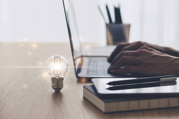 Bright light or glowing lamp with laptop. Business success idea and education, studying and learning concept. Businessman or student knowledge inspiration and cognition development - Photo, Image