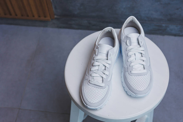White women's leather sneakers close-up. New collection of women's summer leather shoes. - Photo, image