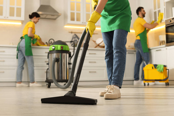 Professional janitors working in kitchen, closeup. Cleaning service - Φωτογραφία, εικόνα