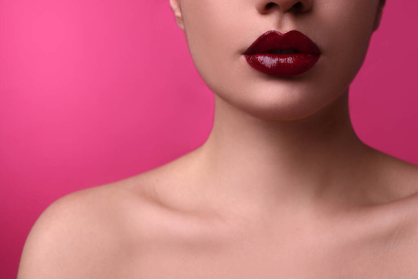 Closeup view of woman with beautiful full lips on pink background - Valokuva, kuva