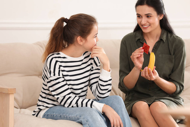 Mother talking with her teenage daughter about contraception at home. Sex education concept - Φωτογραφία, εικόνα
