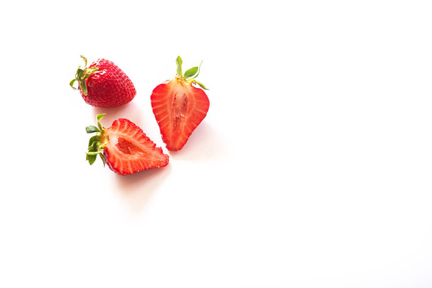Two strawberries isolated on white background. inside view. Sliced strawberries. half a berry. Menu concept, copy space, place for text. top view. Fresh berries. Helthy food. Natural sweet - Φωτογραφία, εικόνα