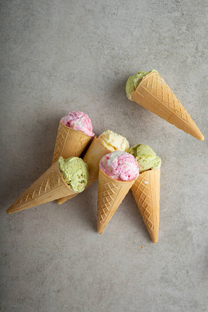 Set of scoops gelato in waffle green pink vanilla top view - Foto, afbeelding
