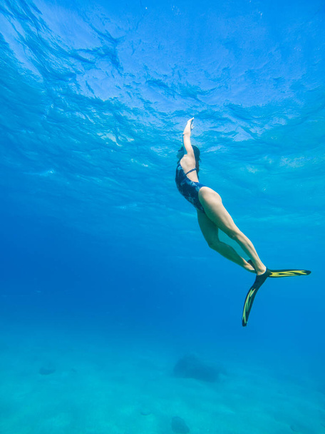 beautiful woman swimming underwater with snorkeling mask and flippers copy space - Fotoğraf, Görsel