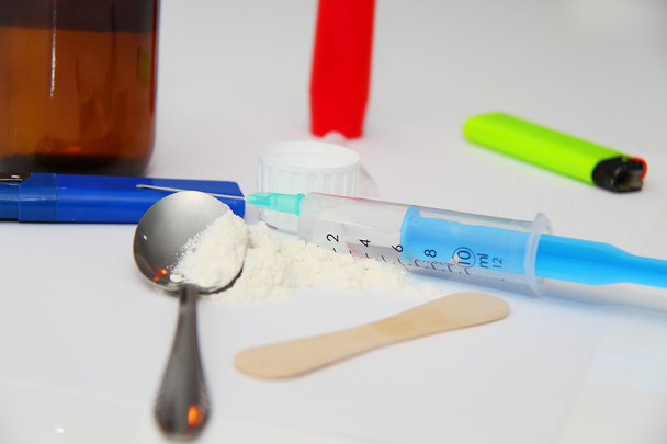 Drug syringe and cooked heroin on spoon - Photo, Image