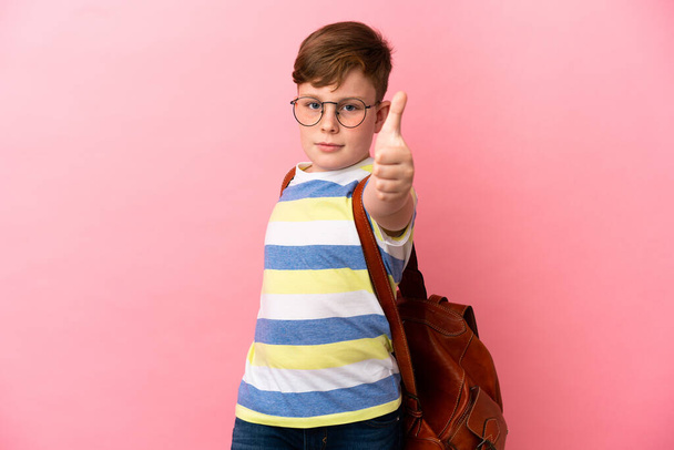 Little redhead caucasian boy isolated on pink background with thumbs up because something good has happened - Foto, immagini
