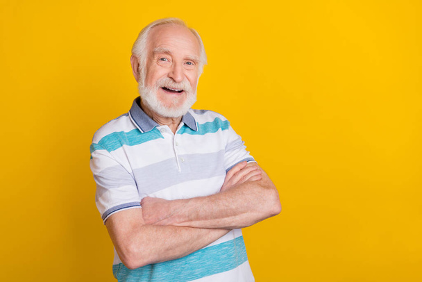 Portrait of attractive cheerful grey haired content man folded arms copy space isolated over bright yellow color background - Valokuva, kuva